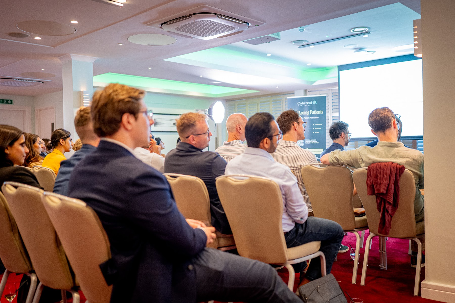 Attendees listening intently during a panel