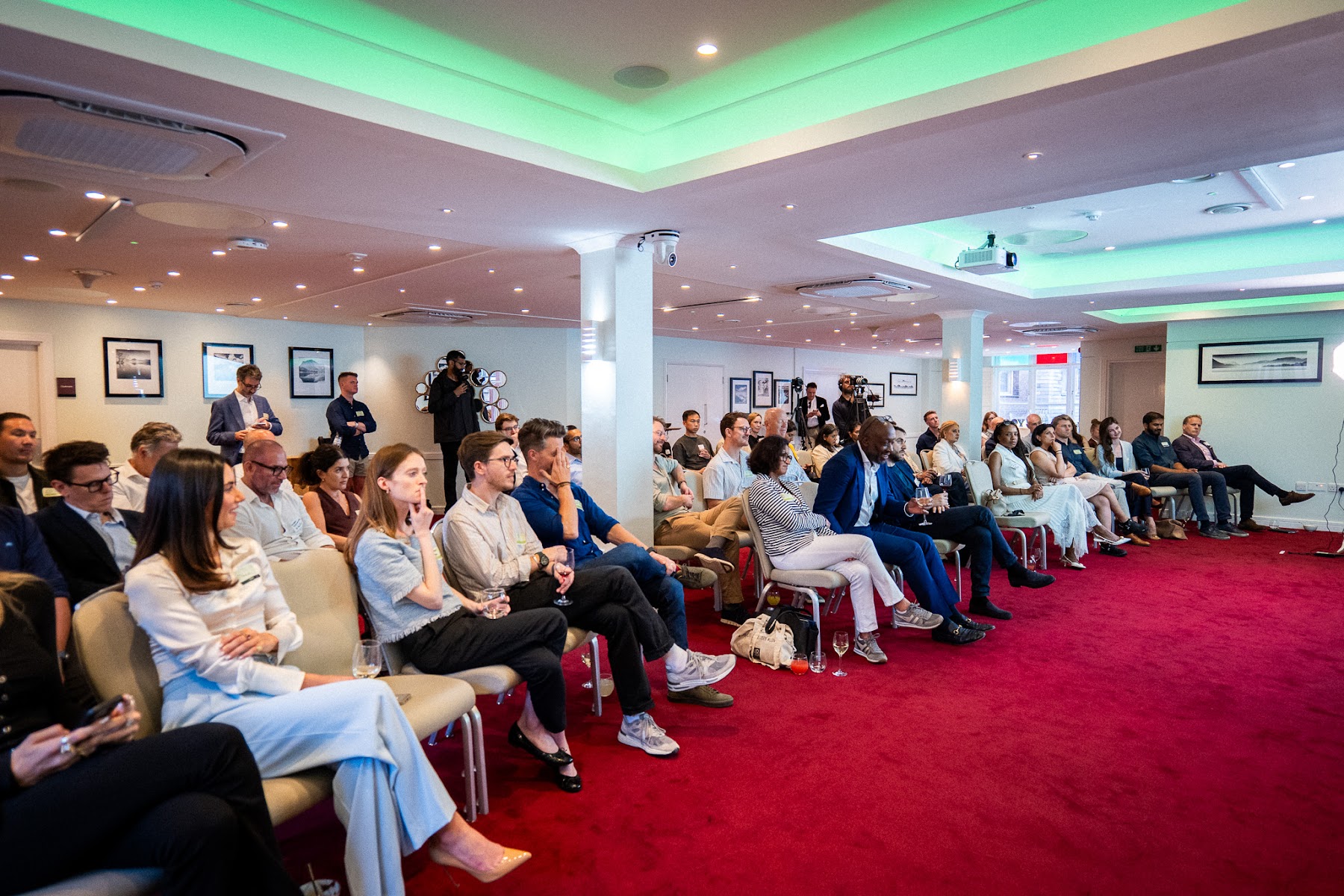 Wide view of the seated audience watching the panel